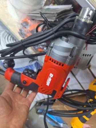 Электродрель D-MAX DM10010, выполненная в оранжево-черном корпусе Bishkek